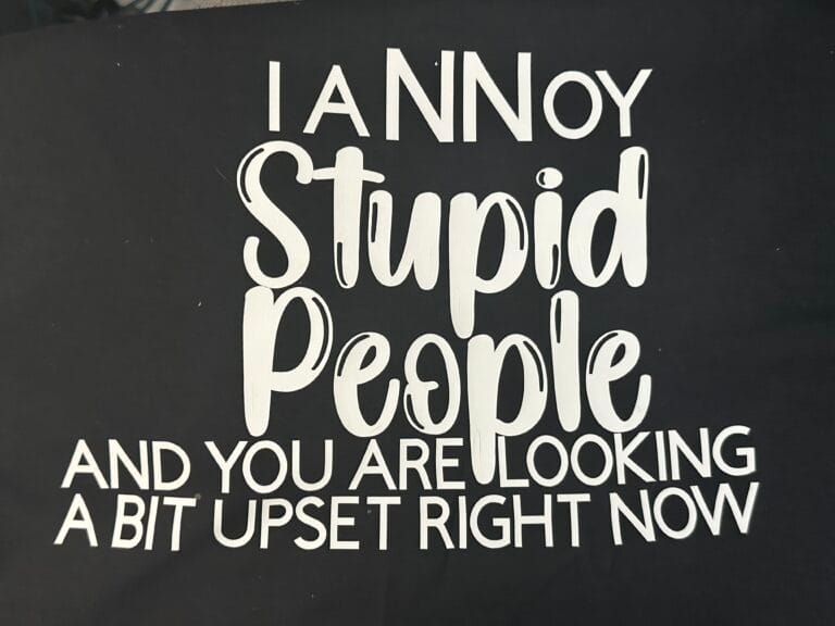 Unisex T-Shirt that has I Annoy Stupid People And You Are Looking A Bit Upset on the front